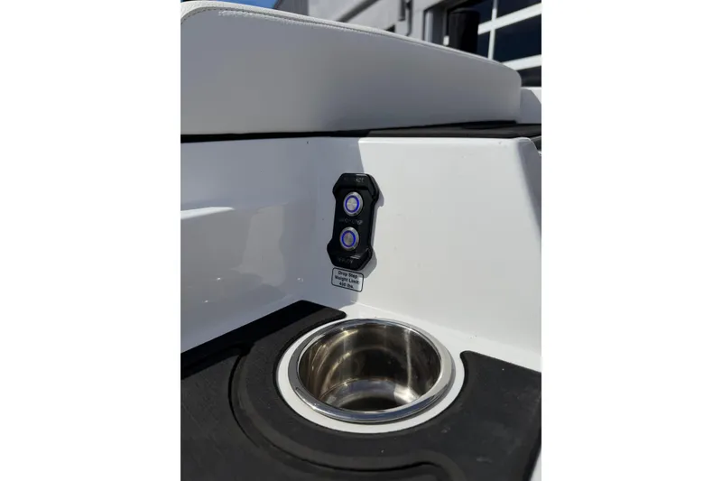 Slide: The Image of 2025 Moomba Makai boat interior with control panel and cup holder. - 11