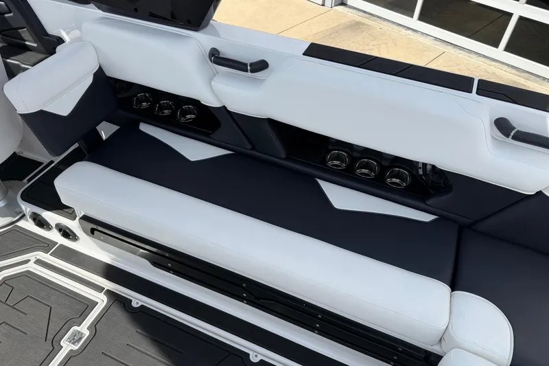 Slide: The Image of 2025 Moomba Makai boat interior with sleek black and white seating and cup holders. - 15