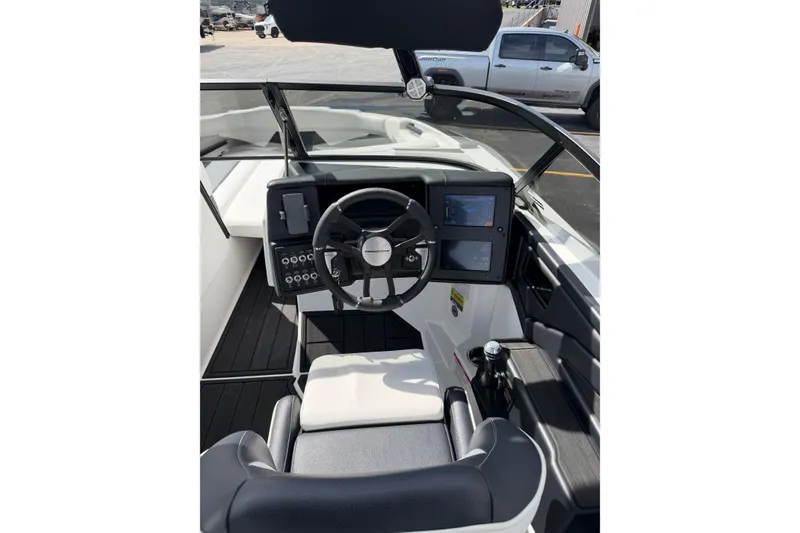 Slide: The Image of 2025 Moomba Makai boat cockpit with modern steering and dual display screens. - 17