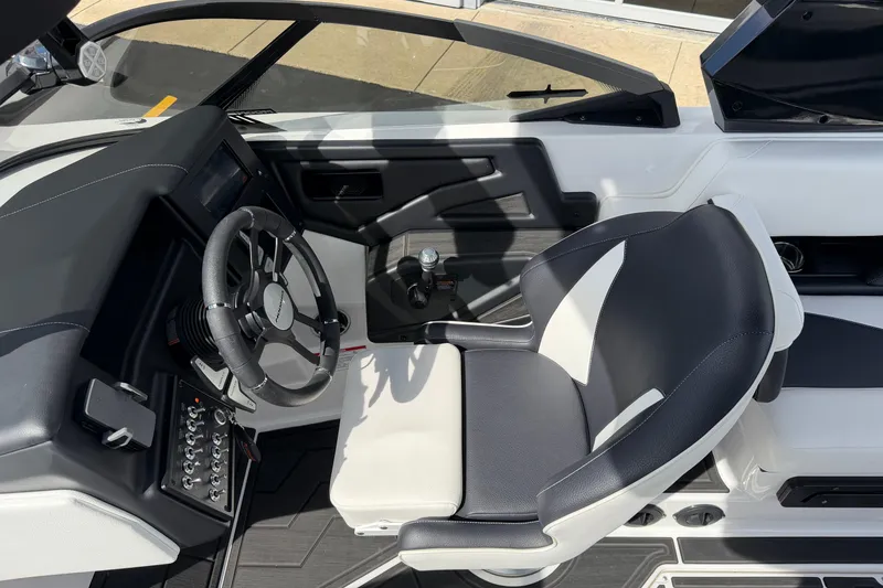 Slide: The Image of 2025 Moomba Makai boat cockpit with modern steering wheel and comfortable seating. - 25