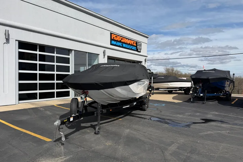 Slide: The Image of 2025 Moomba Makai boat covered, parked outside Performance Marine dealership. - 28