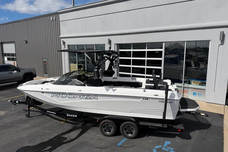 Slide: The Image of 2025 Moomba Makai boat on trailer outside dealership, showcasing sleek design and modern features. - 3