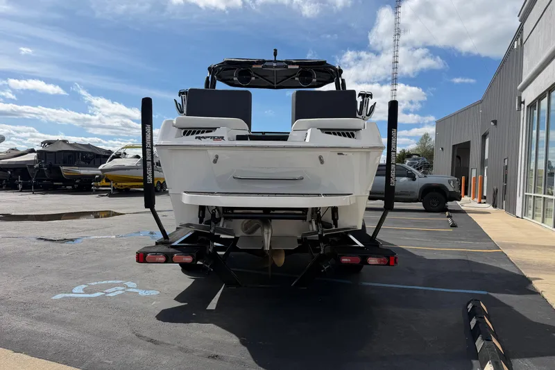 Slide: The Image of 2025 Moomba Makai boat on trailer in parking lot, sunny day. - 5