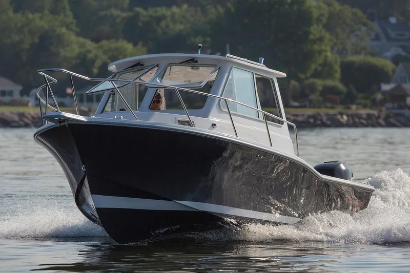 Slide: The Image of Manufacturer Provided Image: 2025 NorthCoast 235 HT boat cruising on water, showcasing sleek design and powerful performance. - 12
