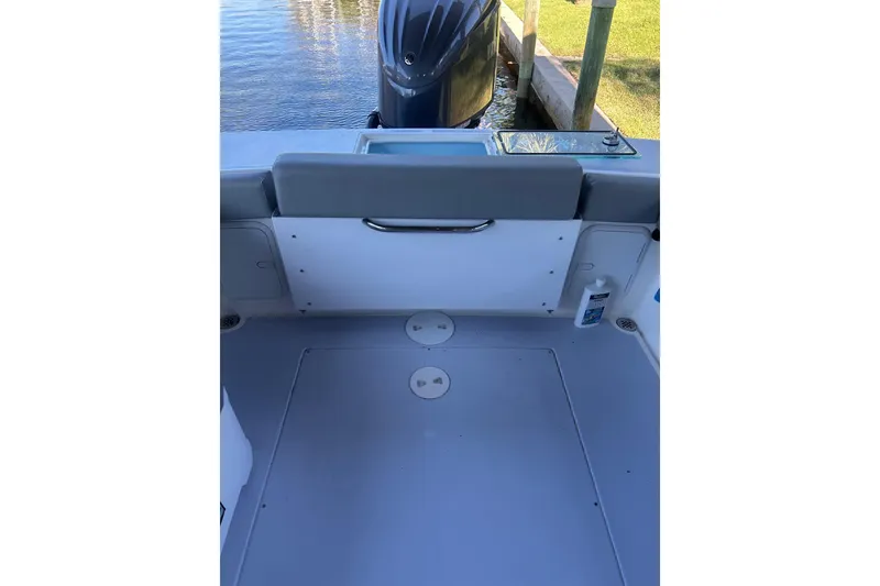 Slide: The Image of 2024 NorthCoast 235 HT boat deck with outboard motor and seating area. - 5