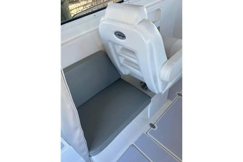 Slide: The Image of 2024 NorthCoast 235 HT boat interior seating with white and gray upholstery. - 7