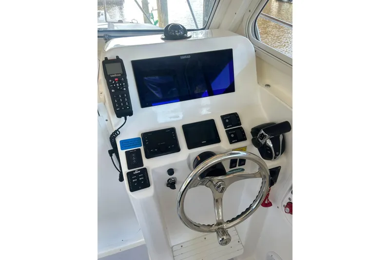 Slide: The Image of Helm of 2024 NorthCoast 235 HT boat with modern controls and navigation equipment. - 9