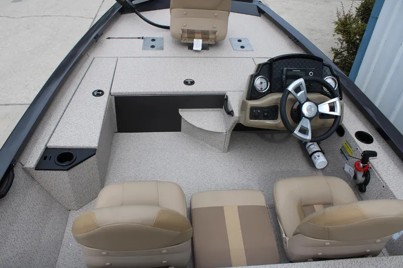 Slide: The Image of 2025 G3 Sportsman 1610 boat interior with steering wheel, beige seats, and dashboard controls. - 10
