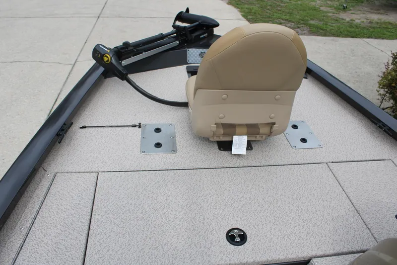 Slide: The Image of 2025 G3 Sportsman 1610 boat interior with beige seating and trolling motor. - 13