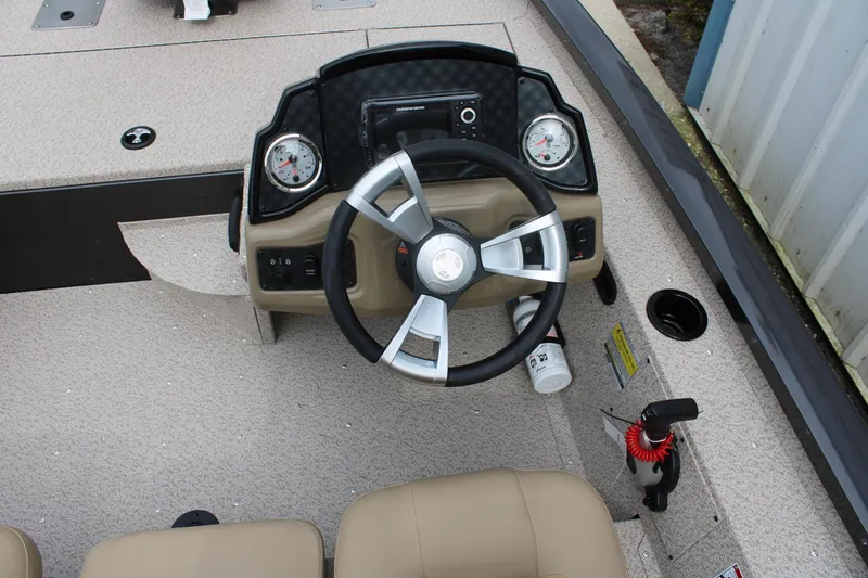 Slide: The Image of Steering console of 2025 G3 Sportsman 1610 boat with gauges and controls. - 14