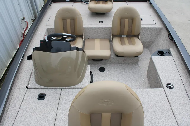 Slide: The Image of 2025 G3 Sportsman 1610 boat interior with beige seating and steering console. - 15