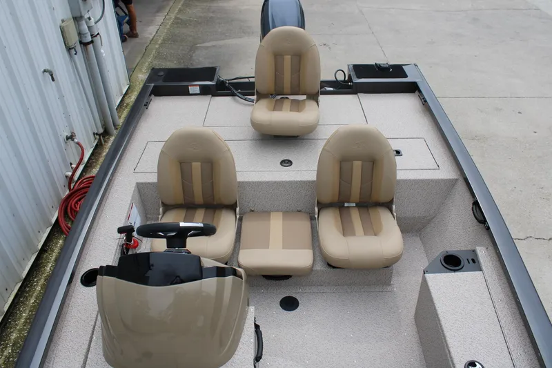 Slide: The Image of 2025 G3 Sportsman 1610 boat interior with beige seating and steering console. - 16
