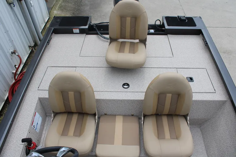 Slide: The Image of 2025 G3 Sportsman 1610 boat interior with beige seats and storage compartments. - 17