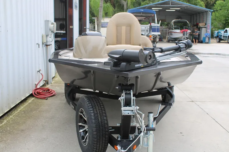 Slide: The Image of 2025 G3 Sportsman 1610 boat on trailer, parked outside a workshop. - 3