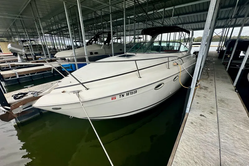 Slide: The Image of 2001 Rinker Fiesta Vee 270 boat docked in a covered marina. - 1