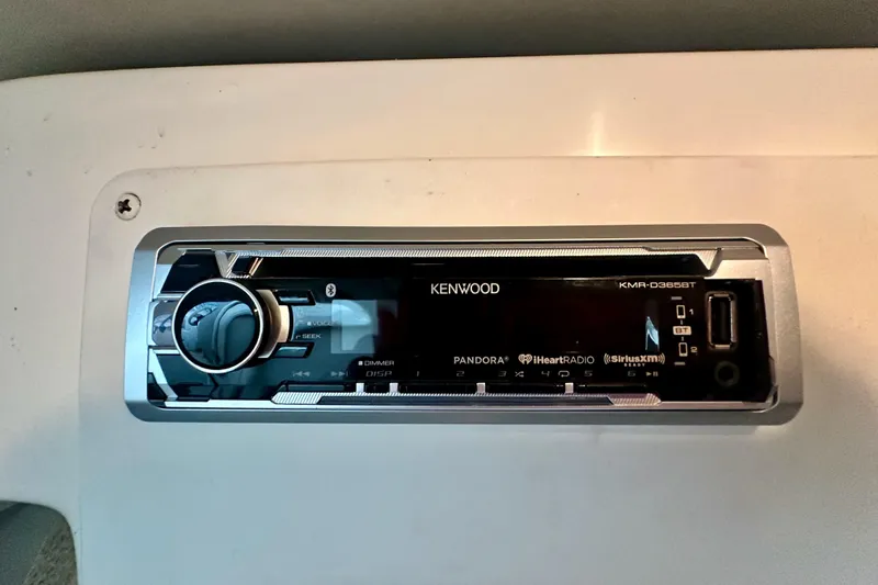 Slide: The Image of Kenwood stereo system in 2001 Rinker Fiesta Vee 270 boat dashboard. - 13