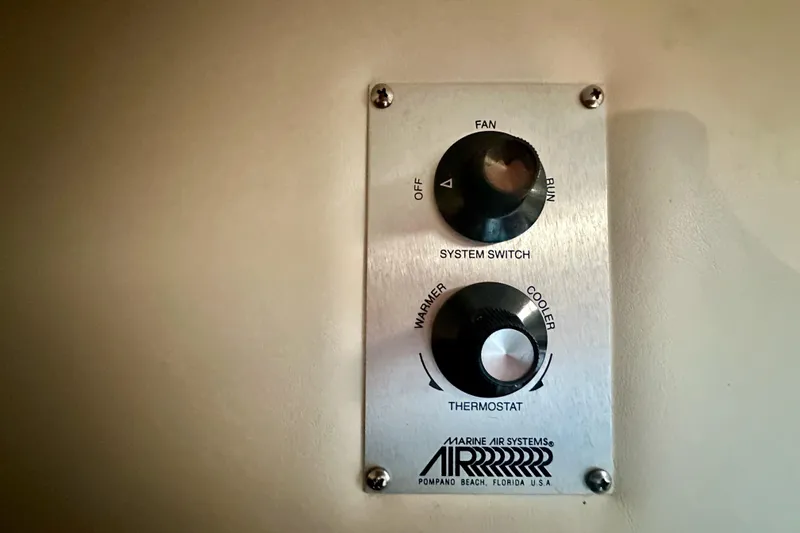 Slide: The Image of Thermostat controls on a 2001 Rinker Fiesta Vee 270 boat, featuring fan and temperature settings. - 15