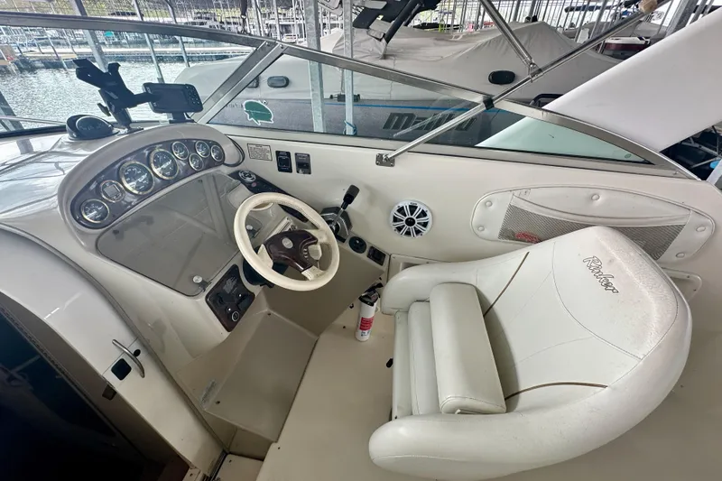 Slide: The Image of Cockpit of 2001 Rinker Fiesta Vee 270 boat with steering wheel and gauges. - 16
