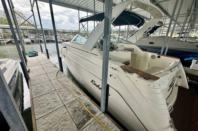 Slide: The Image of 2001 Rinker Fiesta Vee 270 docked in a covered marina slip. - 2