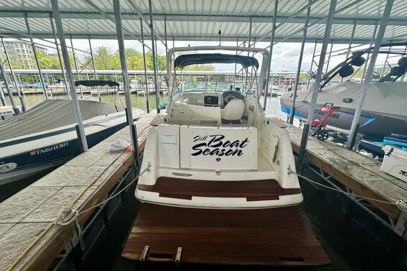 Slide: The Image of 2001 Rinker Fiesta Vee 270 docked in a covered marina, rear view. - 20