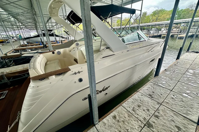 Slide: The Image of 2001 Rinker Fiesta Vee 270 boat docked in a marina, featuring a sleek design and spacious interior. - 3