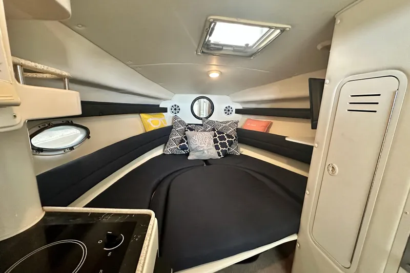 Slide: The Image of Interior cabin of 2001 Rinker Fiesta Vee 270 boat with cozy bedding and modern amenities. - 7