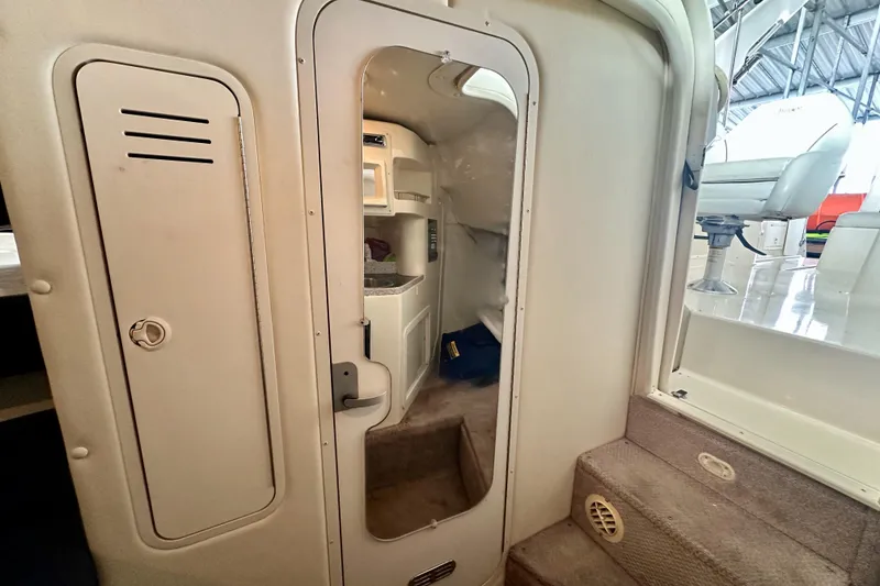 Slide: The Image of 2001 Rinker Fiesta Vee 270 cabin entrance with interior view and seating area. - 8