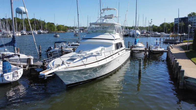Slide: The Image of 1986 Bertram 54 Convertible yacht docked in marina. - 1