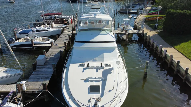 Slide: The Image of 1986 Bertram 54 Convertible yacht docked at marina. - 11