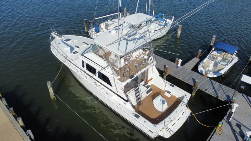 Slide: The Image of Aerial view of a 1986 Bertram 54 Convertible yacht docked. - 12