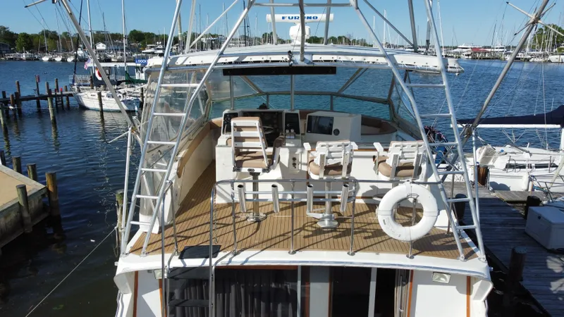Slide: The Image of 1986 Bertram 54 Convertible yacht in harbor, top deck view. - 13