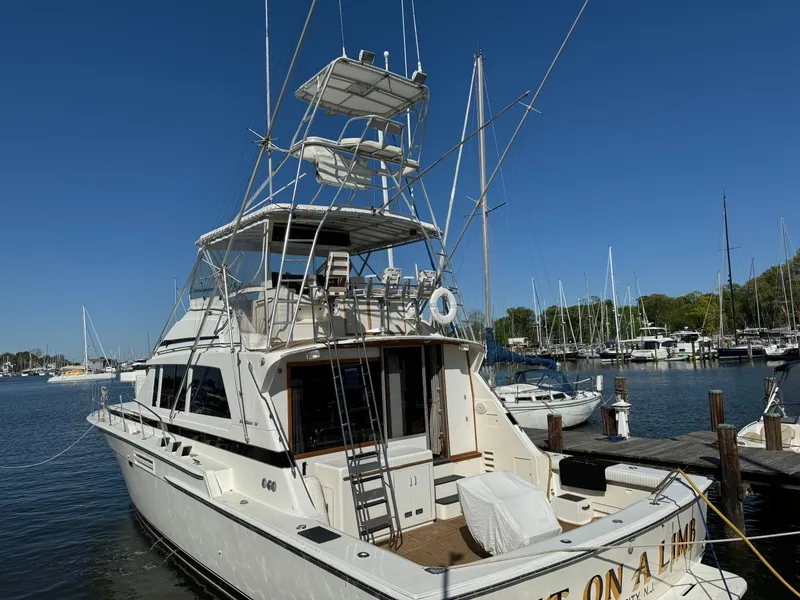 Slide: The Image of 1986 Bertram 54 Convertible yacht docked at marina. - 16