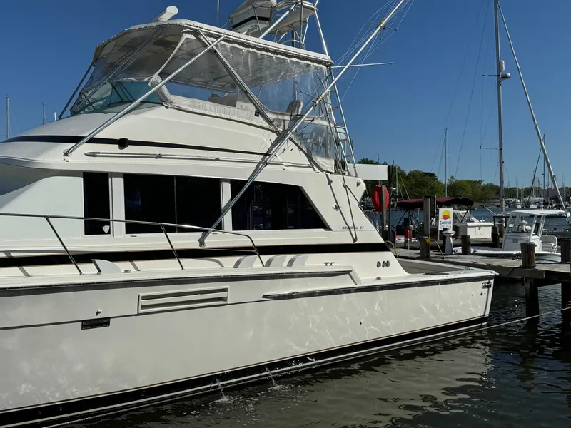 Slide: The Image of 1986 Bertram 54 Convertible Yacht docked at marina. - 18