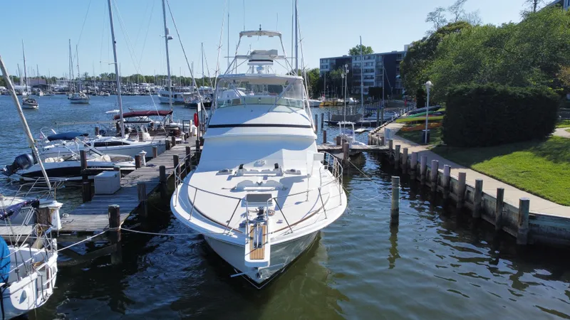 Slide: The Image of 1986 Bertram 54 Convertible Yacht docked in marina. - 2