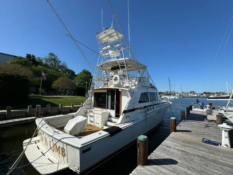 Slide: The Image of 1986 Bertram 54 Convertible Yacht docked on a sunny day. - 22