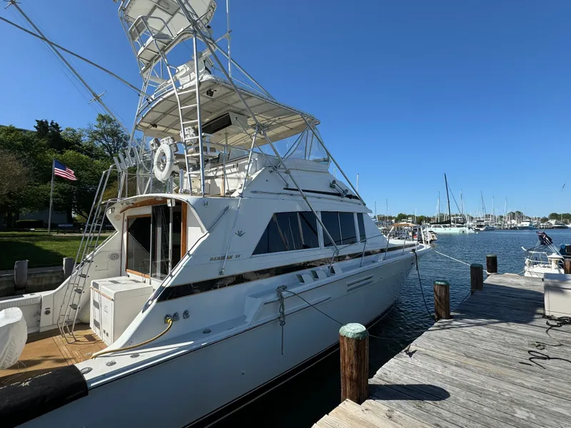 Slide: The Image of 1986 Bertram 54 Convertible Yacht docked on a sunny day. - 23