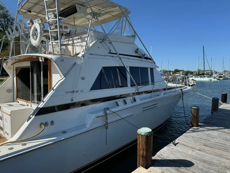 Slide: The Image of 1986 Bertram 54 Convertible Yacht docked on a sunny day. - 24