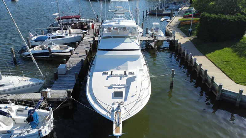 Slide: The Image of 1986 Bertram 54 Convertible Yacht docked at marina. - 3