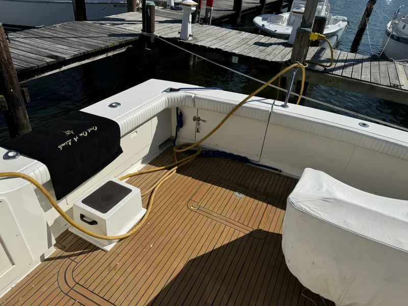 Slide: The Image of 1986 Bertram 54 Convertible Yacht at dock with wooden deck. - 31