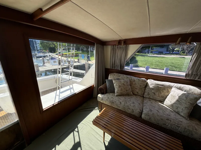 Slide: The Image of Interior of a 1986 Bertram 54 Convertible yacht with sofa and table. - 33