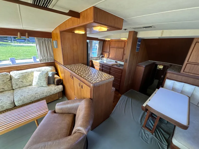 Slide: The Image of Interior of a 1986 Bertram 54 Convertible yacht, featuring a cozy living area. - 37
