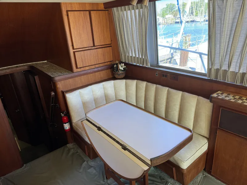 Slide: The Image of Interior of 1986 Bertram 54 Convertible yacht with dining table. - 39