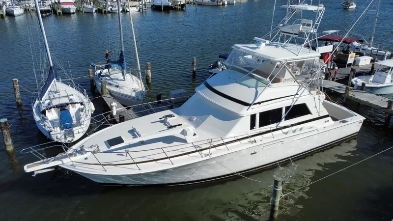 Slide: The Image of 1986 Bertram 54 Convertible yacht docked at marina. - 4