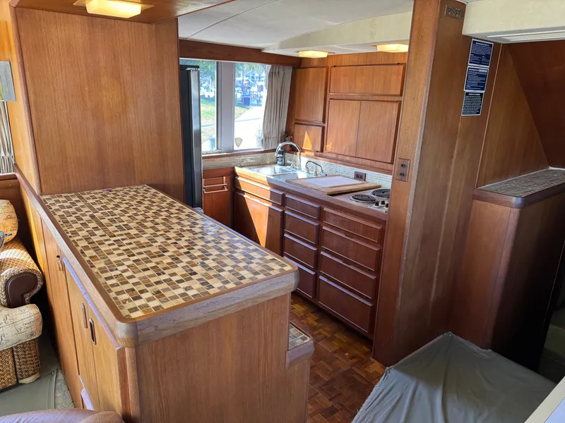 Slide: The Image of 1986 Bertram 54 Convertible yacht interior with wooden kitchen. - 40