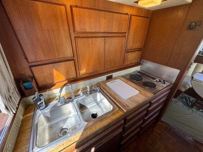 Slide: The Image of 1986 Bertram 54 Convertible kitchen area with sink and stove. - 43