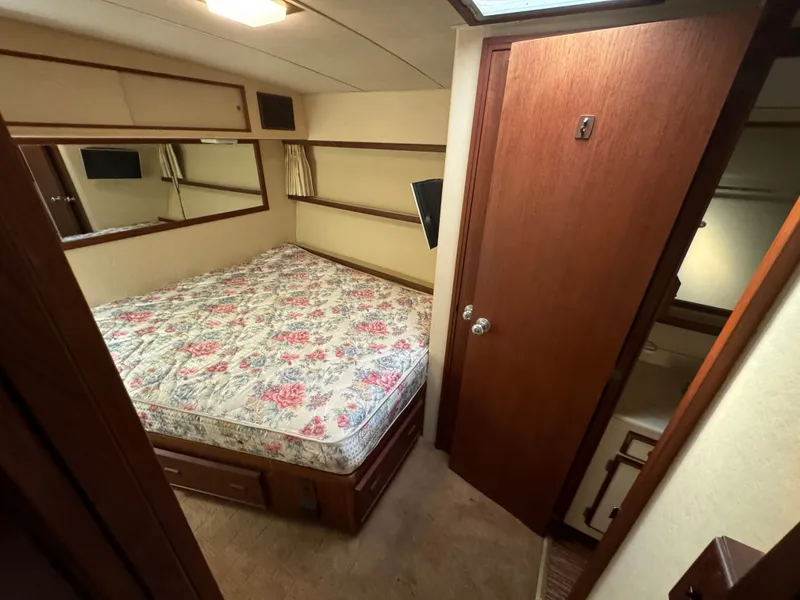 Slide: The Image of Interior of 1986 Bertram 54 Convertible with bed and wooden doors. - 49