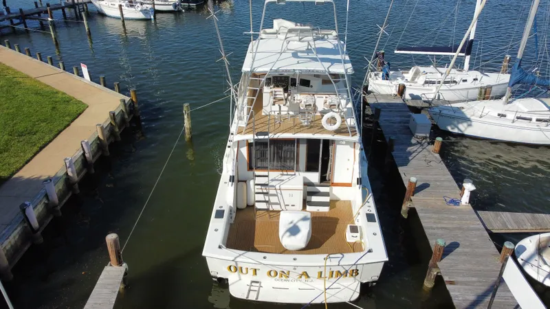 Slide: The Image of 1986 Bertram 54 Convertible yacht docked at marina. - 8