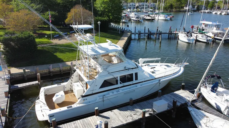 Slide: The Image of 1986 Bertram 54 Convertible yacht docked at marina. - 9