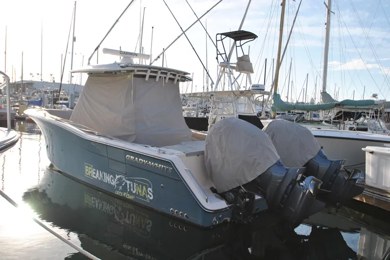 The Image of 2021 Grady-White Canyon 336 boat docked in marina with covered engines. - 0