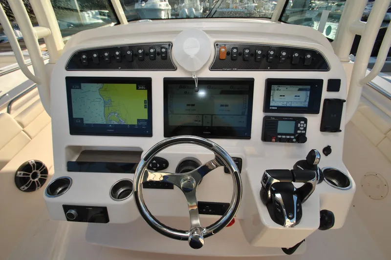Slide: The Image of Dashboard of 2021 Grady-White Canyon 336 boat with navigation screens and controls. - 11